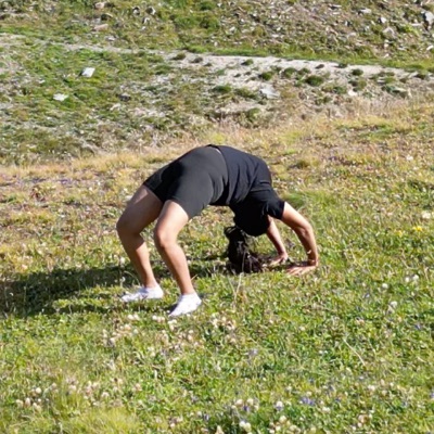 Nayana Nagaraja practising Chakrasana on an alpine meadow